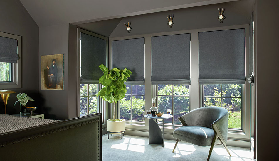 Bedroom window treatment ideas for a traditional bedroom include motorized Flat Roman Shades made of Wool Blend in Charcoal