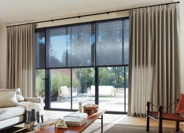 Patio doors featuring inverted pleat drapery in wool blend fleece in a living room with a white couch and brown coffee table