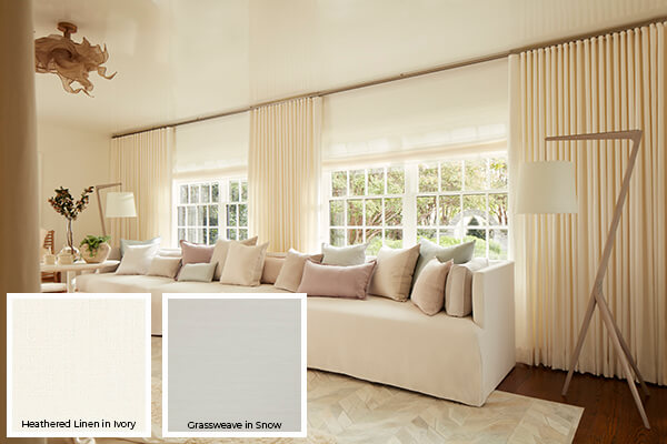 One of the colorful window treatment trends in 2026 is the use of warm whites and ivory seen on these living room drapes