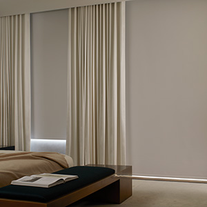 Types of blinds include Roller blinds made of Cora Blackout in White which helps darken a modern bedroom for better sleep