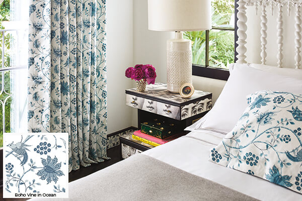 Floral patterns, one of the window treatment trends 2026, is seen in this bedroom's Boho Vine in Ocean Tailored Pleat Drapery