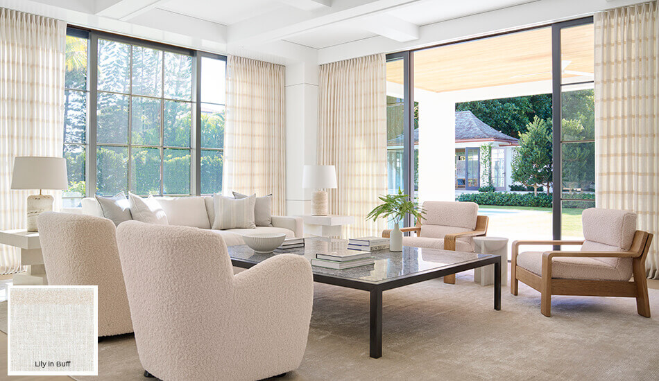 One of the colorful window covering ideas and trends 2026 is the use of warm, light neutrals seen on these living room drapes