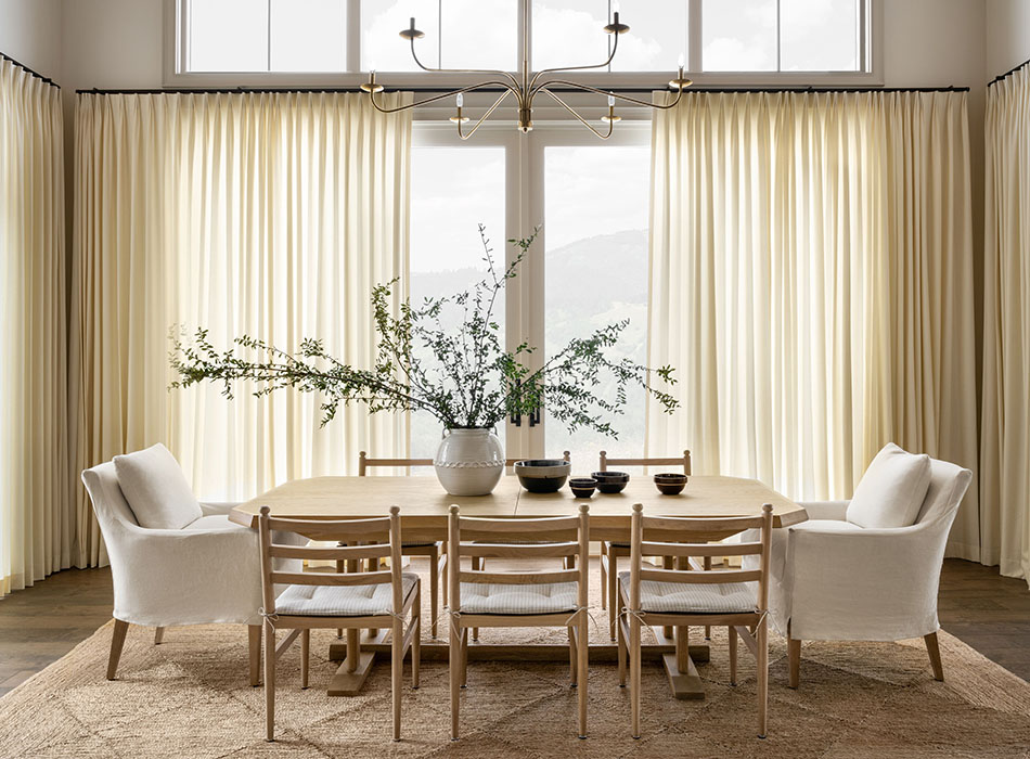 Tailored Pleat Drapery in Wool Blend Snow installed as a sliding glass door curtain for a high-end dining space.