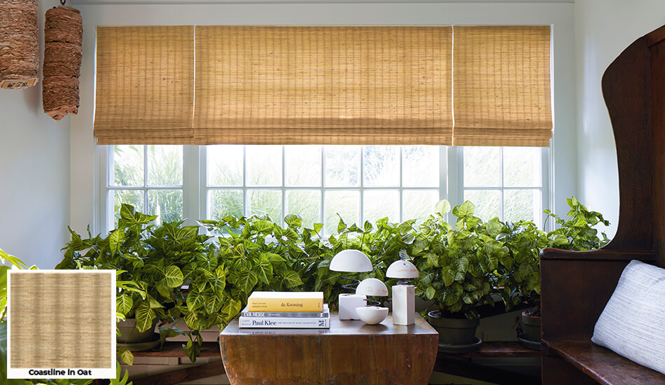 One of the window treatment trends in 2026 is the use of woven textiles seen on these Waterfall Woven Wood Shades in a sunroom