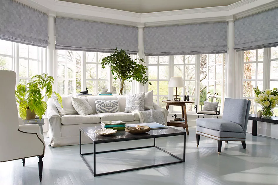 Spacious living room with flat Roman shades, representing popular window shade styles and elegant fabric shade options for large windows