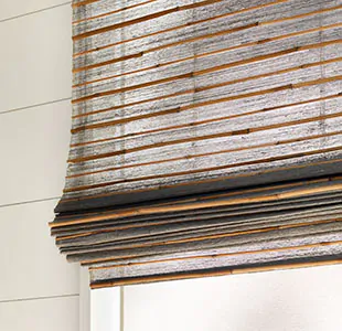 A close-up of a Woven Wood Shade made of Sullivan in Sand without lining shows lots of light filtering through