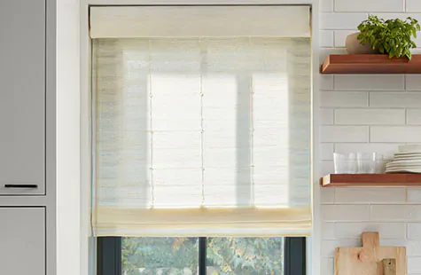Bamboo window blinds made of Coastline in Muslin filter light into a modern farmhouse kitchen with open wood shelves