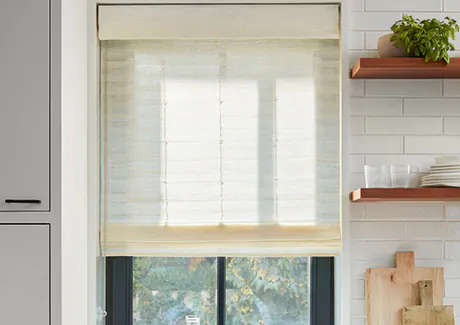 A farmhouse kitchen has Woven Wood Shades made of Coastline in Muslin with no lining for some privacy and lots of light as natural window coverings that let light in
