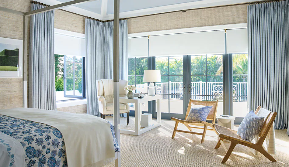 A coastal bedroom has curtains to keep heat out made of Tailored Pleat Drapery in Vanda, Sky with lining