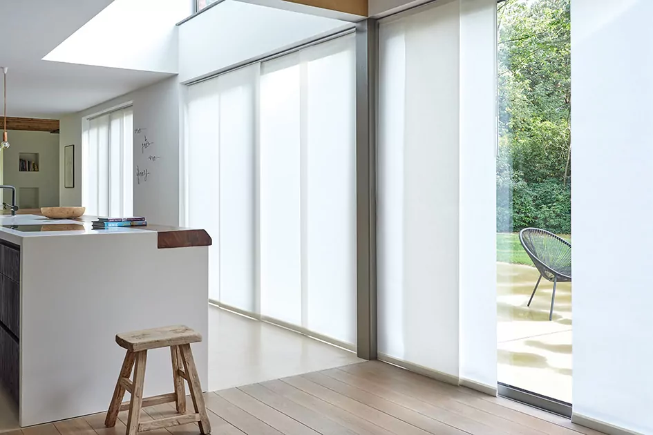 Sliding glass doors with white vertical blinds, showcasing window shade options for large openings and modern alternatives to curtains