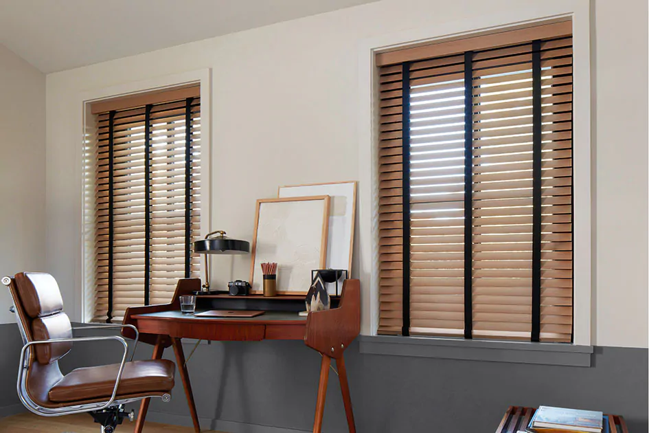 Mid century modern (MCM) blinds in a warm wood tone with black decorative tape in a sunlit home office
